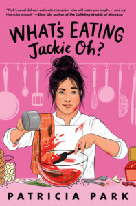 Illustrated cover for What's Eating Jackie Oh? A Korean American teenge girl is wearing a white chef's outfit, which is stained with a red substance in several spots. She has her black hair up in a messy bun and an orange kitchen towel draped over her right shoulder. She is in the middle of mixing something red, brown, and green with a black spatula in a clear bowl. The counter in front of her is crowded with gloves of garlic, green onions, measuring spoons, and what might be a container of gochujang. She is half smiling and looks determined. There is a line of kitchen tools, utensils, and pans hung up behind her against the pink background.