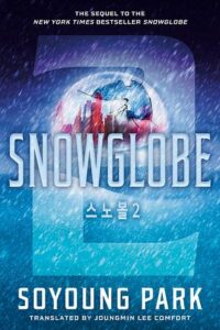 Cover of Snowglobe. There is a giant transparent 2 on the cover. Behind it is snow falling on a snow covered landscape. In the background behind the title is a giant sphere of glass with a city inside it.