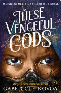 Illustrated cover for These Vengeful Gods. The cover is a close-up of the top half of a person's face. They have brown skin and dark brown eyes, and they appear to be wearing what looks like a mask. They also have what looks like a hood pulled up over their head, so only a few strands of brown hair is available. Their brow is furrowed and they are focused on something just to the right of the viewer.