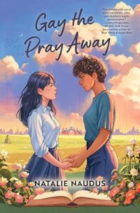 The cover of Gay the Pray Away has two young women standing facing each other and holding hands. The one on the left has long dark hair and is wearing a blouse and skirt. The one on the right has short curly brown hair and is wearing a t-shirt and jeans. They're outside with an open book in front of them with flowers on either side of it.
