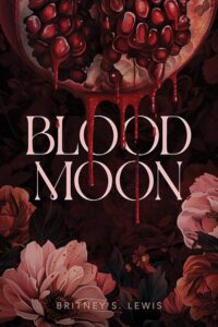 Cover of blood moon. A pomegranate is dripping juice and there are flowers below that are various shades of pink.