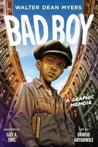Cover of the book bad boy. A young Black man in a brown pageboy cap is at the center. He has a book tucked under one arm and there are three or four story buildings on either side of him with many windows.