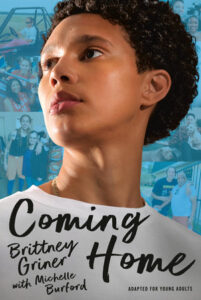 Cover for Coming Home. The cover features Brittney Griner in almost-profile, looking off to the spine of he book. She has a serious expression on her face and is wearing a white crew-neck shirt and a necklace just peeking out from the collar. Behind her is a muted collage of candid photos of her.