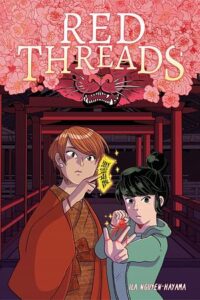 The cover of the book Red Threads. Two young people are standing in front of a series of red gates. The one nearest them has many pink flowers and the bottom of a lion's face. The person on the right has short light brown hair and is holding out something that is gold and glowing with black characters written on it. The person on the right is slightly shorter and has black hair. She's holding back a red string in one hand that is wrapped around three fingers of her other hand like it is a sling shot. 