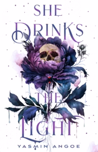 Illustrated cover of She Drinks the Light. The background is white. The title and most of the image is various shades of navy and purple. There is a large flower in the center that includes the stem and roots. All seems to have blue and grey liquid dripping from the leaves and petals. In the center of the one bloom is a white skull with a drip of blood above the cavity for the nose. There is also a drop of blood on a petal and a drop of blood that is in the air below that petal. There are purple dots all around the illustration.