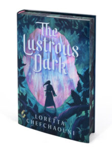 Book cover for The Lustrous Dark. It seems like a young person in a dress is standing at the mouth of a cave. There are vines around the edges of the book. One branch has a gold ring hanging on it. In front of the person is a pink and blue shimmering castle of other large structure. 