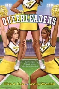 The cover of the book queerleaders. There are three young people in yellow and white and dark green or black uniforms with a large hornet on the chest. They have yellow pom poms. The one on the right (light skin and light brown wavy hair) and the one on the left (Black with braided and a bun) are staring into each other's eyes. The third has brown skin and is standing on their thighs. Her face is not visible. Between them are the words, they're here. They're queer. They came to cheer.