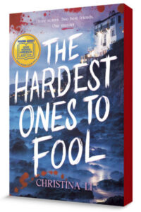 Book cover for The Hardest Ones to Fool has the title in white capital letters that seem to be painted over a rugged beach with a huge white house up on a cliff above. There are blood splatters here and there and lights along the ridge in the background.