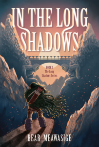 Illustrated cover for In the Long Shadows by Bear Meawasige. A teenager stands with her back to the viewer on a cliff's edge. She has long black hair and is wearing a cloak/cape made out of what looks like furs, brown pants, and shoes with fur up to her knees. She has a bow and a quiver of arrows on her back. She is facing a stone bridge between two mountains, which looks like it's balanced on the back of two stone figures. There is a strong wind that blows her hair, the cape, and several red leaves.