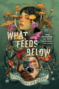 Book cover of What Feeds Below includes a quote by Nick Cutter. "Gory, claustrophobic...best read in sunlit places." A girl has her eyes looking to the side. Around her face are mushrooms and flowers and a butterfly. Below her and the title is an inverted image of her with an eye socket open and a red centipede crawling on her chest. An eyeball is off to the side with another bug on it. There are flowers near, but they are a different kind and the mushrooms are glowing and have eyes on tentacles.